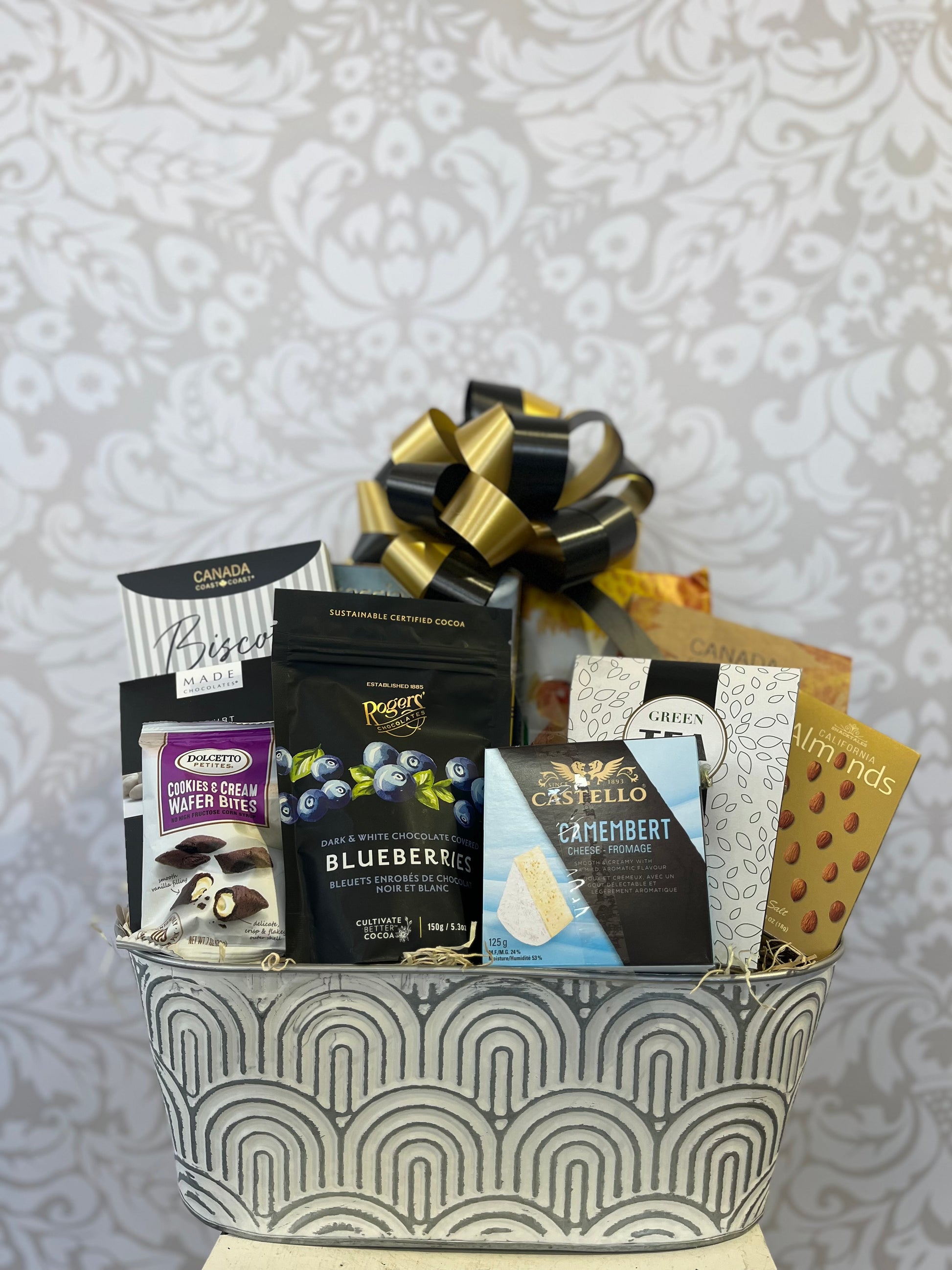 Feels Like Home Gift Basket in a keepsake planter with tea, biscotti, chocolates, crackers and sweet treats