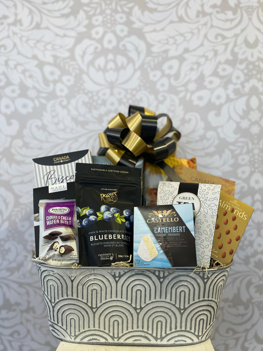 Feels Like Home Gift Basket in a keepsake planter with tea, biscotti, chocolates, crackers and sweet treats